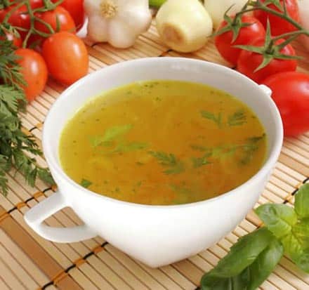 gut healing soup in a white mug with herbs